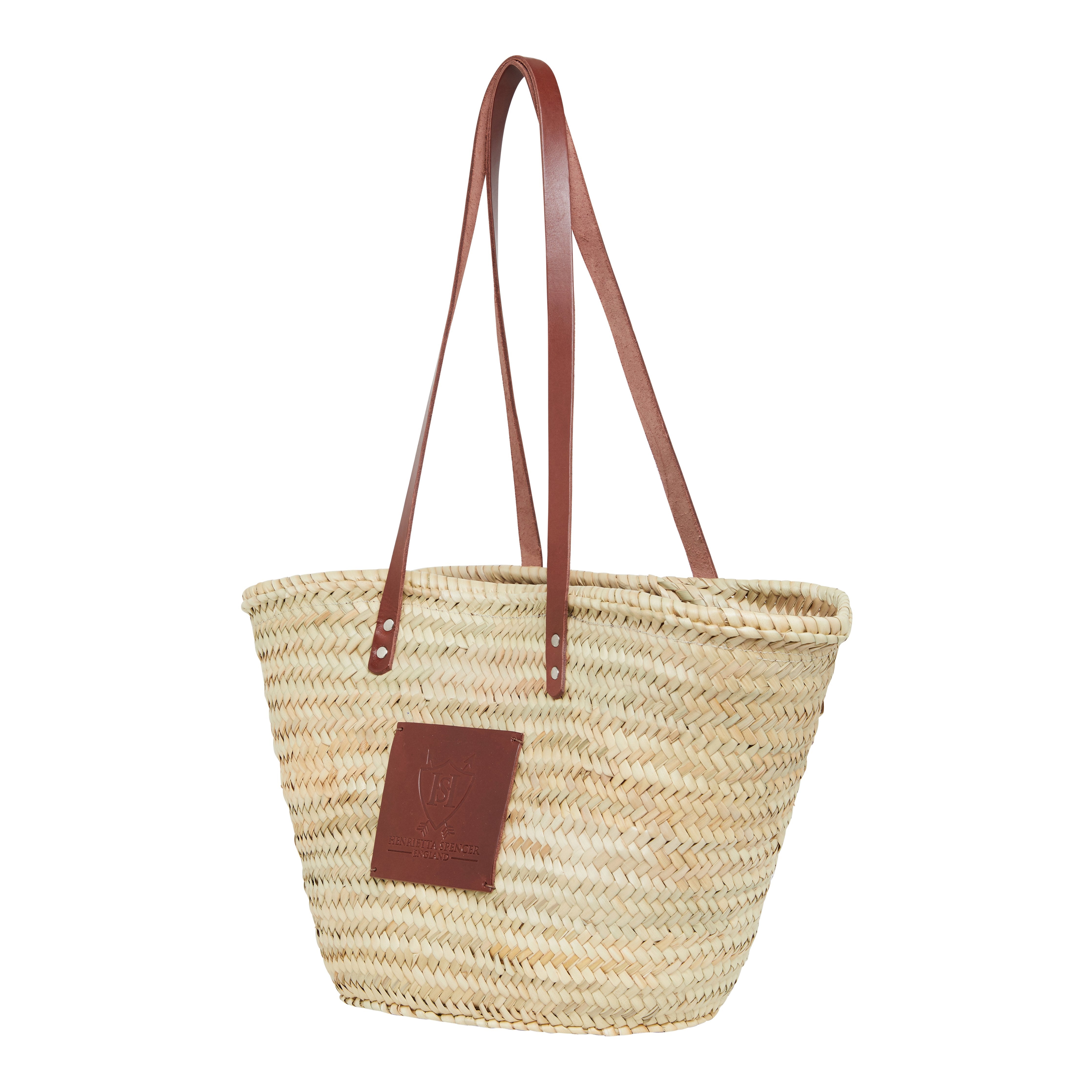 woven basket bag with brown leather handles